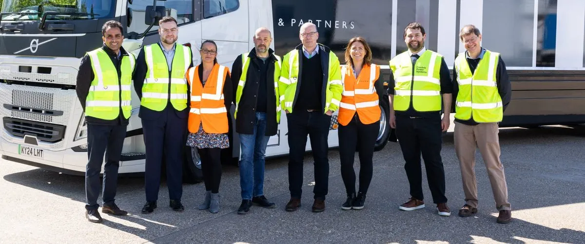 Project JOLT partners in hi-vis jackets standing in front of an electric John Lewis Partnership truck